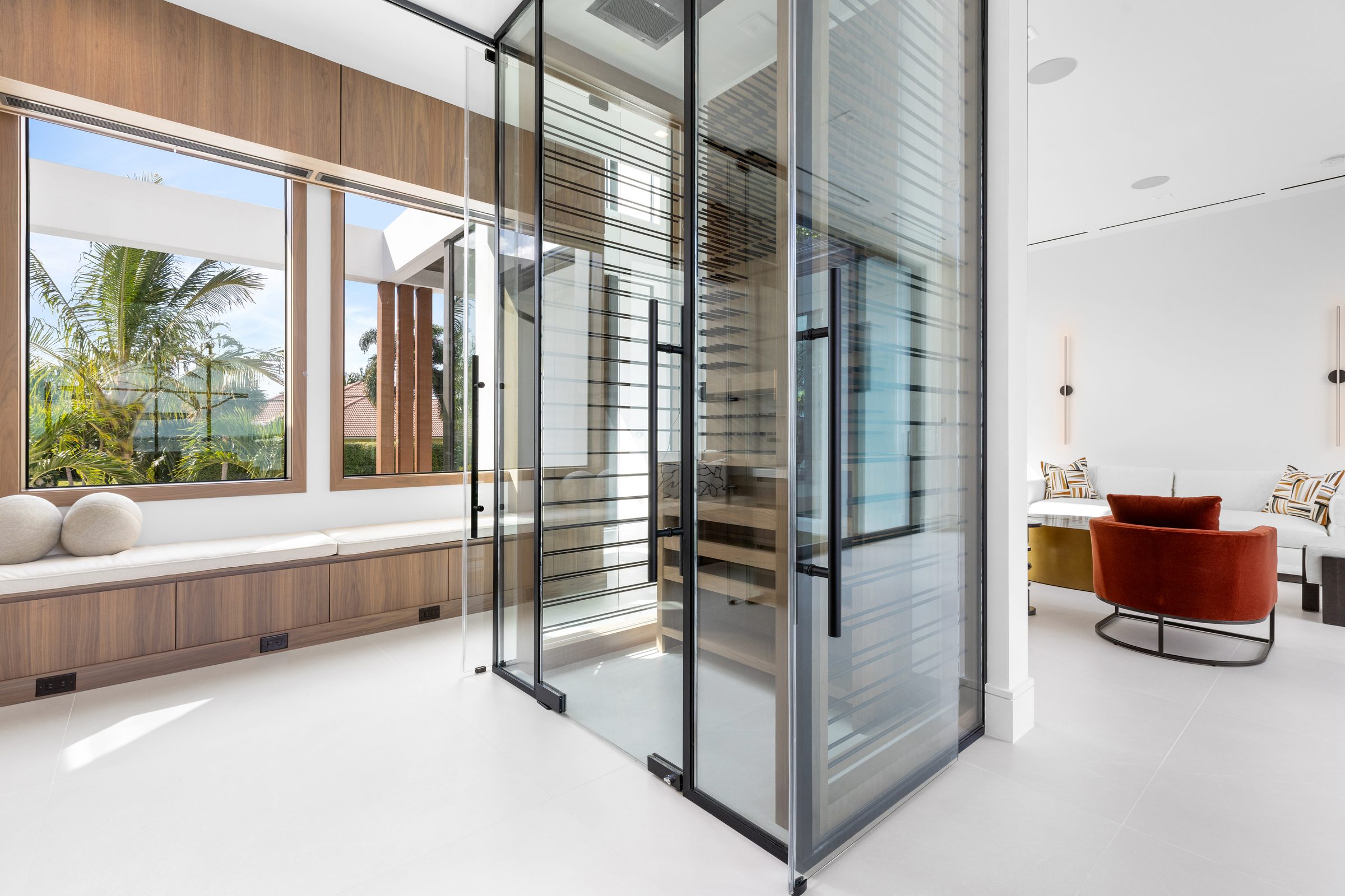 Glass-walled wine room in Ocean Ridge — built by Varga Homes