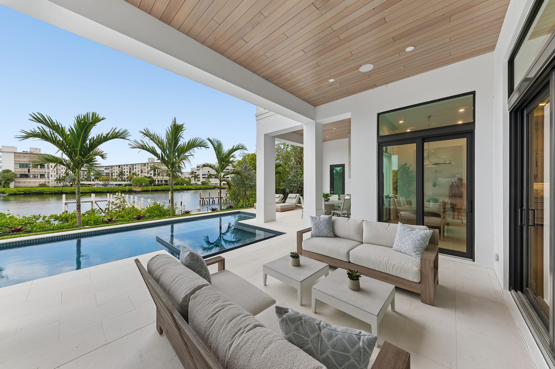 Covered loggia overlooking the pool on Hypoluxo Island, Lantana — built by Varga Homes